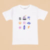 White kids' t-shirt with colorful "SURF" beach-themed graphics